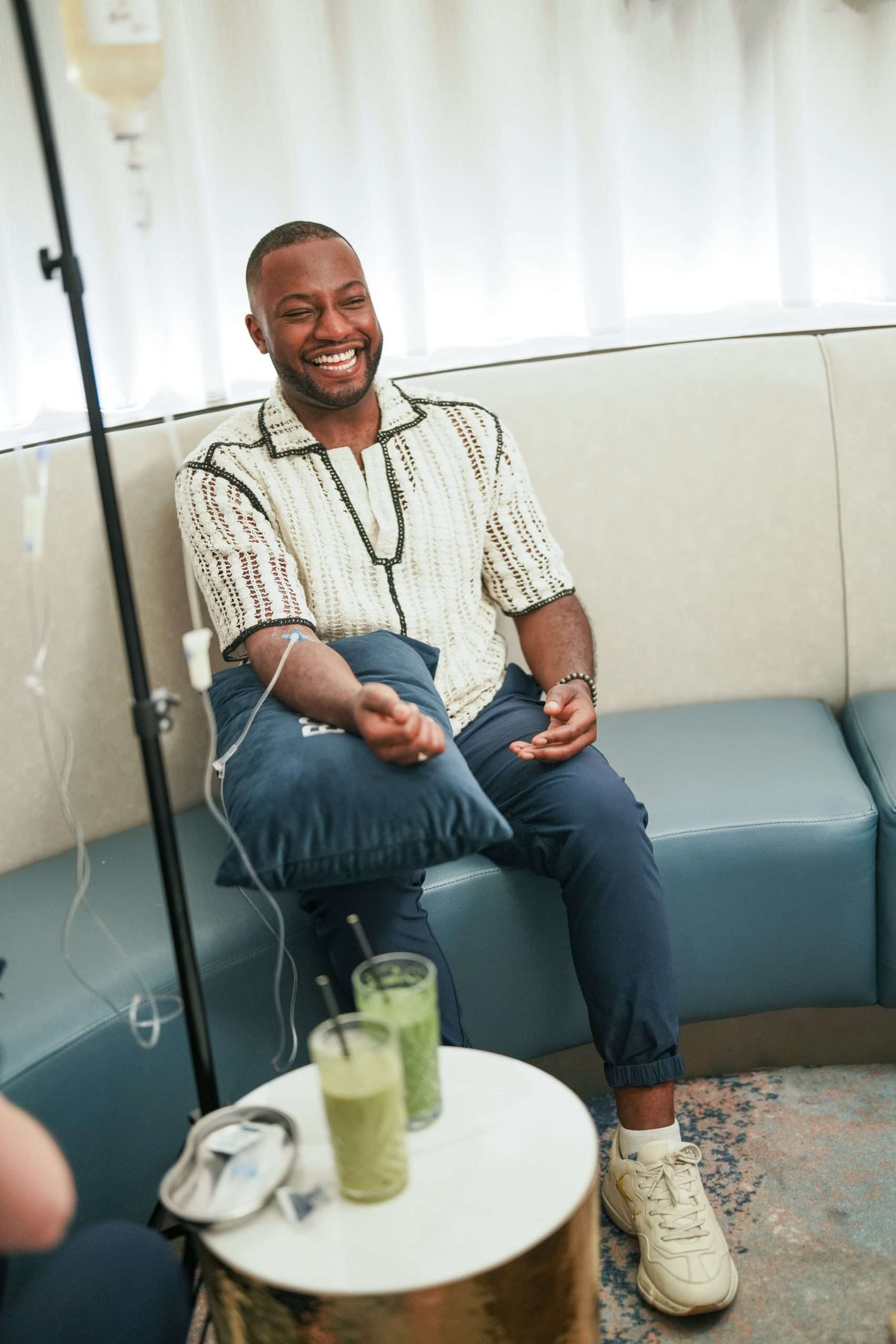 IV Infusion Energy & Recovery Man smiling during IV infusion therapy session