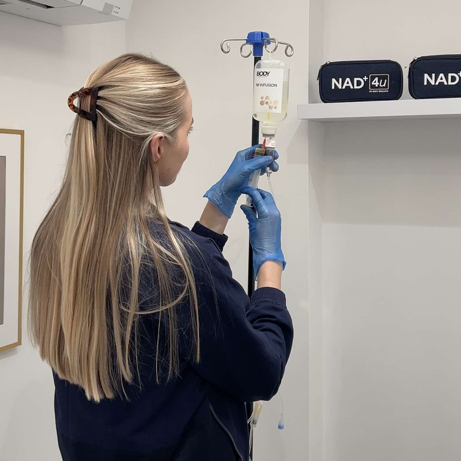 Nurse Preparing IV Drip – Total Health Physiotherapy x Body Brilliant Nurse preparing IV infusion drip in modern wellness clinic
