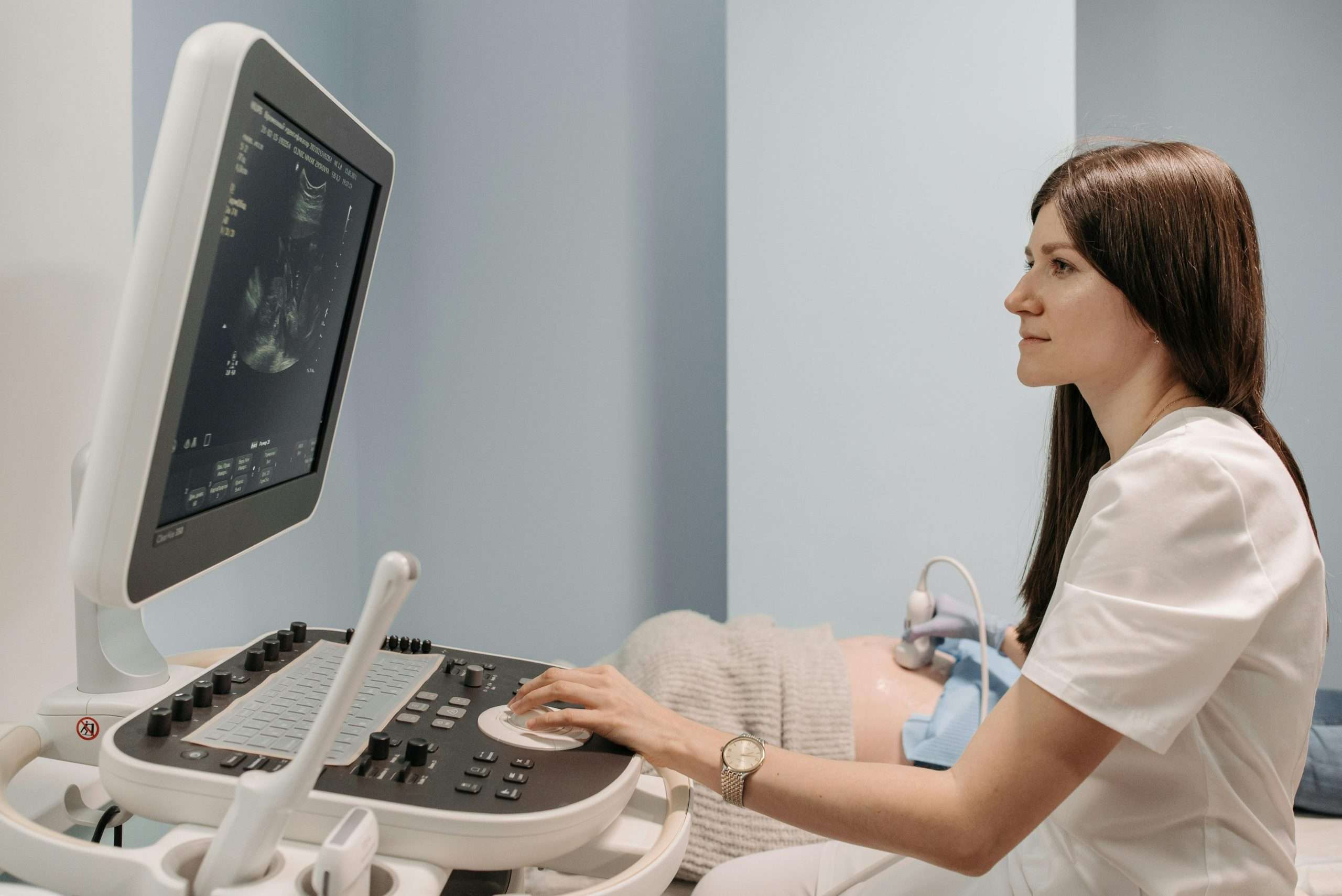 Clinician performing pelvic health ultrasound assessment as part of women’s physiotherapy care.