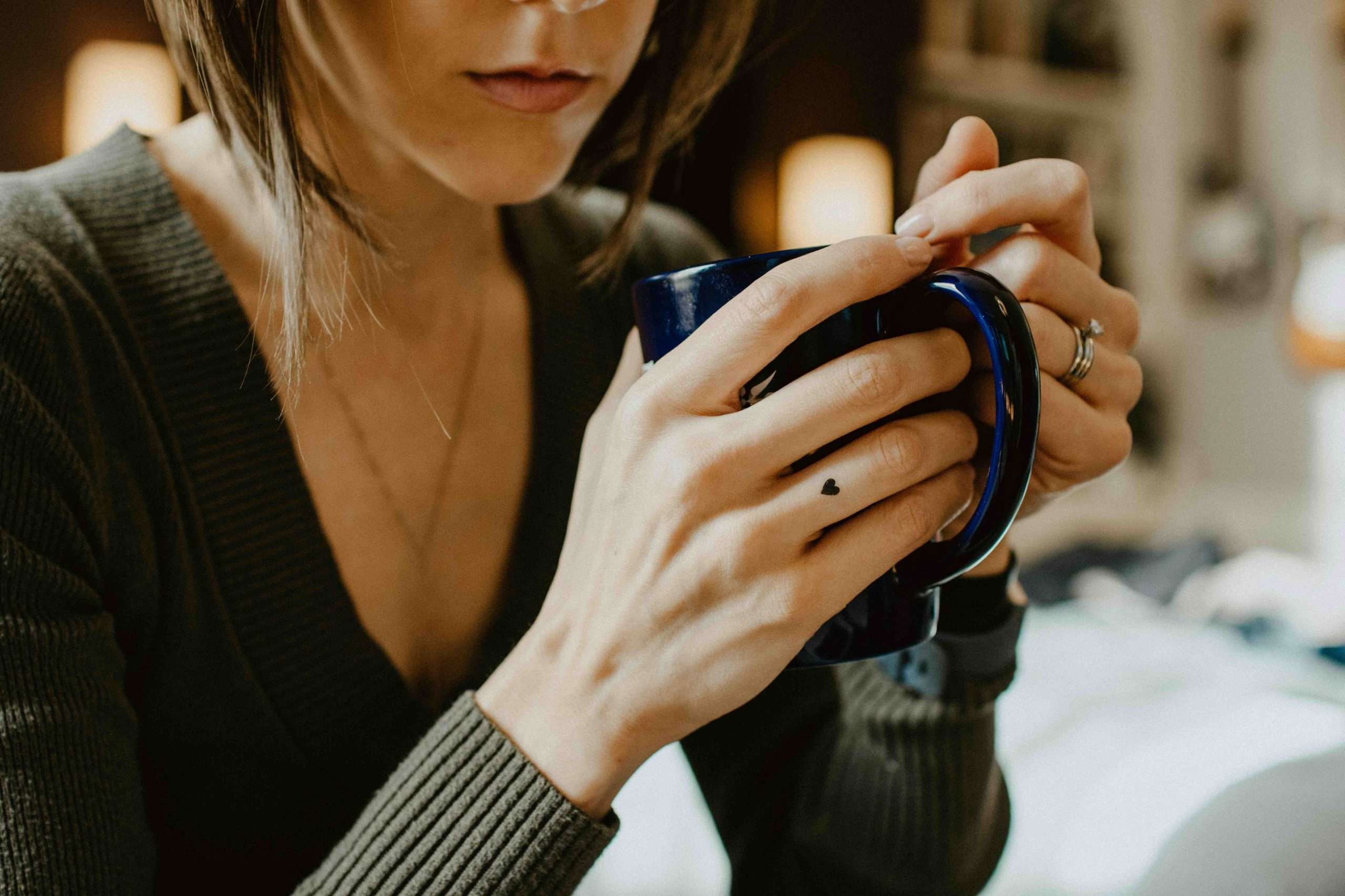 Woman holding a mug and reflecting quietly in a calm moment